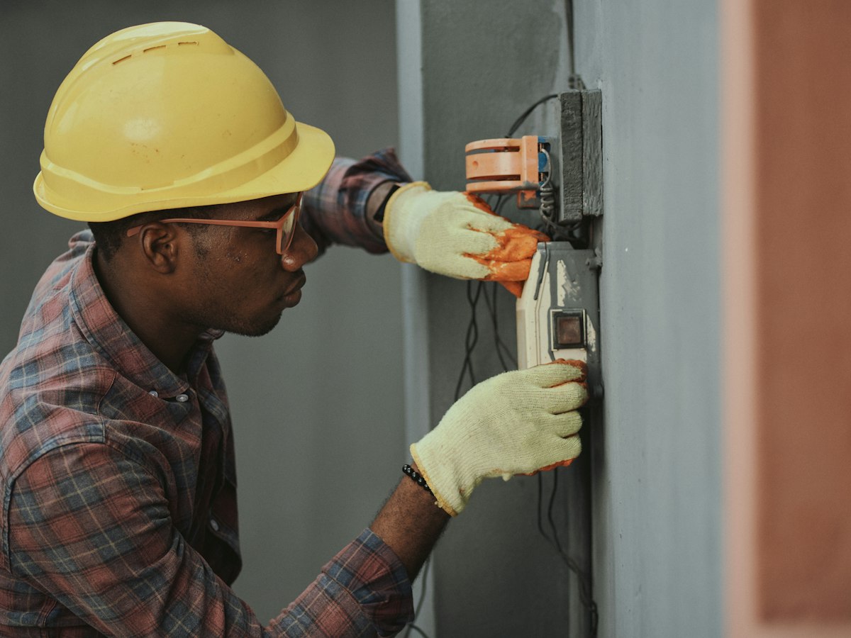 Electrician installing an exterior box